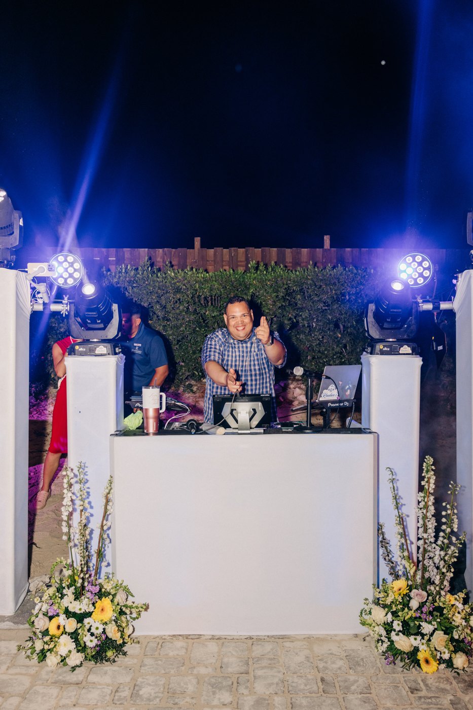 Ruuben at his white DJ booth with blue stage lighting